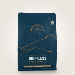 Partial view of the Driftless coffee bag showing blue packaging and mountain artwork
