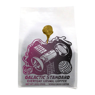 Galactic Standard Espresso Blend bag featuring purple space artwork and a gold seal