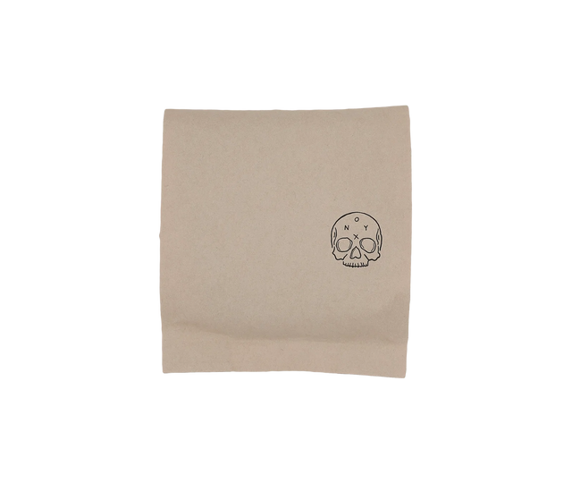Brown kraft coffee bag for Tropical Weather with a small black skull logo in the lower right