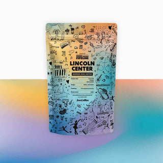 Lincoln Center Summer iced coffee pouch against a pastel rainbow gradient background