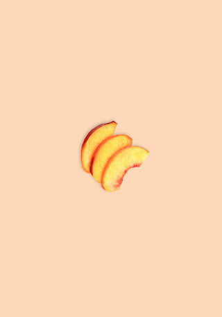 Three apricot slices on a peach background to evoke apricot notes in Rwanda Kanzu coffee.
