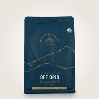 Dark blue Organic Off Grid coffee bag with bold roast label and mountain line art and USDA Organic badge