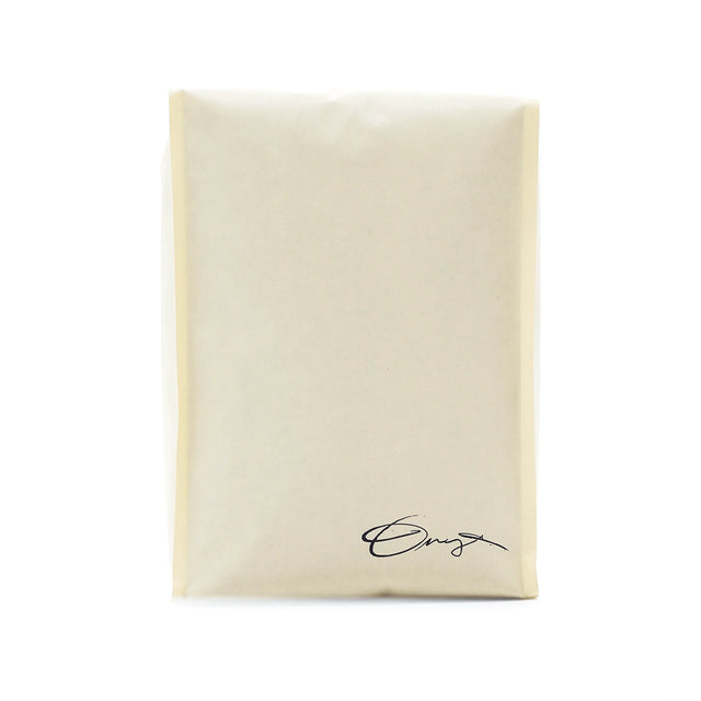 Beige coffee bag with a handwritten signature at the bottom