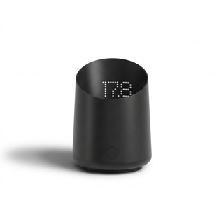 Subminimal Subscale palm-sized black cylinder with LED readout visible through the Tritan shell.