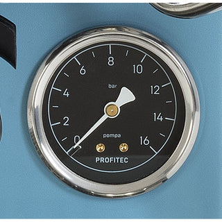 A close-up of a pressure gauge with a black face, silver chrome bezel, white needle, and gold-toned details. The brand name 'PROFITEC' is printed at the bottom of the gauge face, which is mounted on a light blue panel.