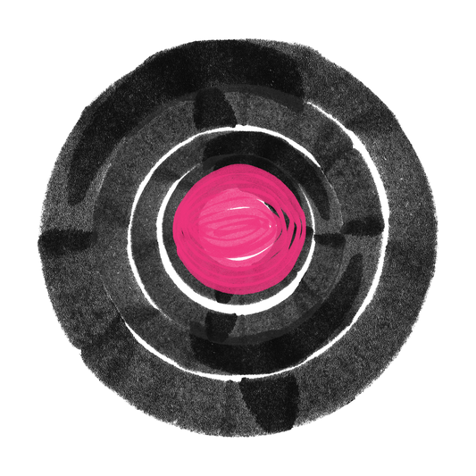 Abstract close up of a black vinyl record with a bright pink center label.