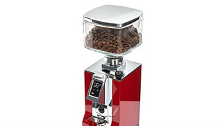 Crystal clear glass hopper with a chrome lid on a red Eureka Mignon coffee grinder