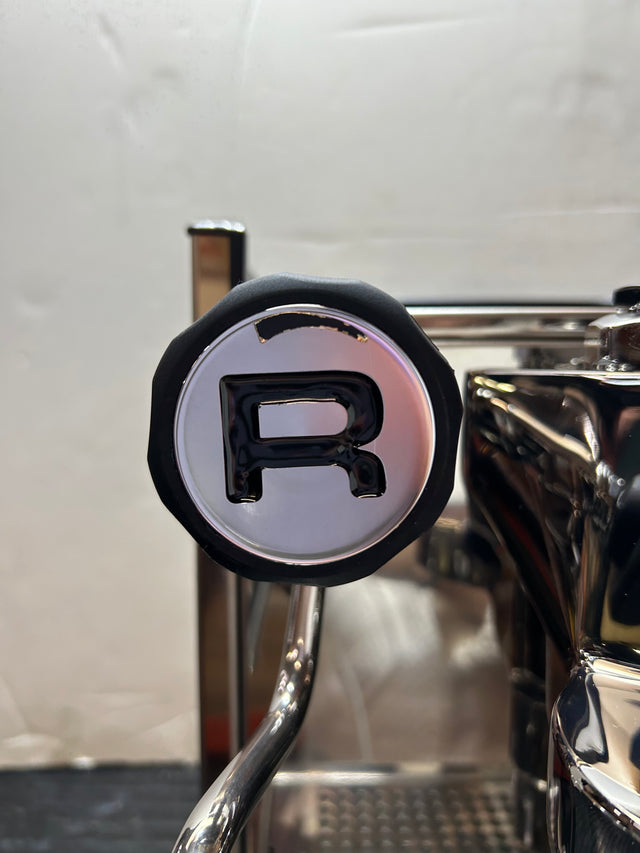 Close up of the Rocket Appartamento copper espresso machine top left area showing chrome housing and circular detail.