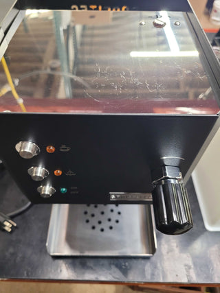 Open top view of the Profitec GO showing a stainless steel top with a glass cover and protective foam surrounding the area