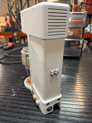 Open box Weber Key Grinder on a workshop bench with vented front panel and a logo.