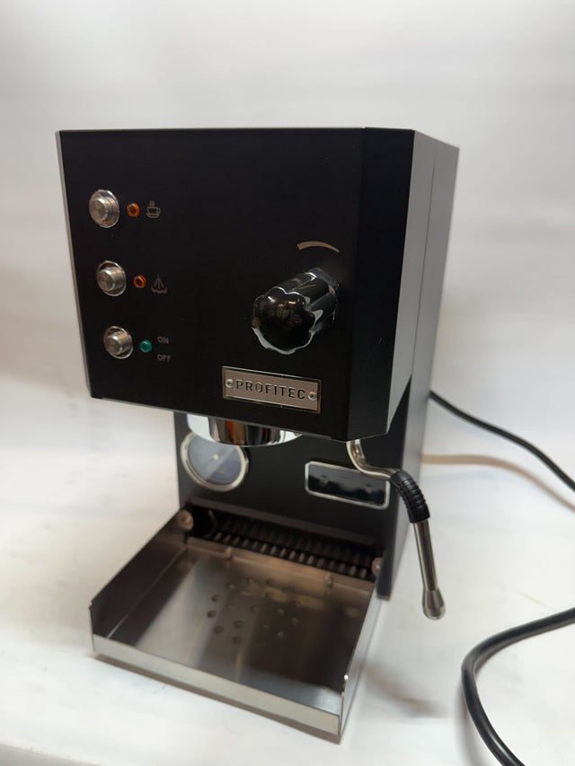 Open box Profitec GO espresso machine with black body chrome trim and a portafilter in place.