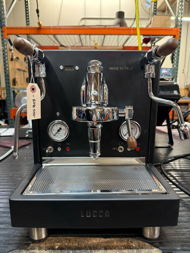 Front view of LUCCA M58 espresso machine with dual wooden portafilters and Made in Italy label