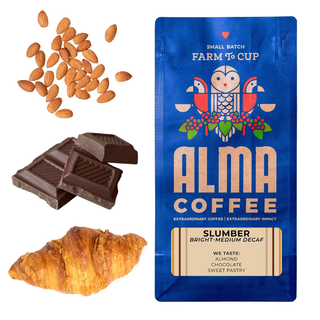 Blue Alma Coffee Slumber bag with almonds chocolate and a croissant beside it