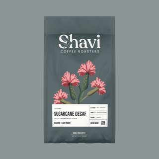 Colombia Sugarcane Decaf bag featuring Shavi Coffee Roasters logo with pink floral artwork.