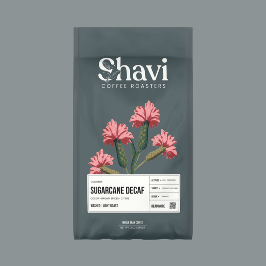 Colombia Sugarcane Decaf bag featuring Shavi Coffee Roasters logo with pink floral artwork.