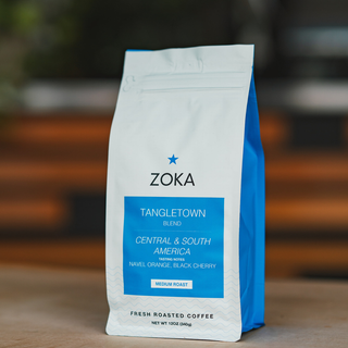 Tangletown Blend coffee bag shown at an angle with white front, blue side and blue label