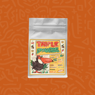 White coffee bag with a colorful Triple Double label featuring a toucan against an orange backdrop.