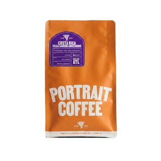 Orange coffee bag labeled Costa Rica Villa Sarchi Anaerobic with a purple label and Portrait Coffee branding