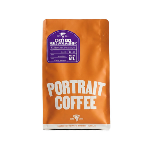 Orange coffee bag labeled Costa Rica Villa Sarchi Anaerobic with a purple label and Portrait Coffee branding