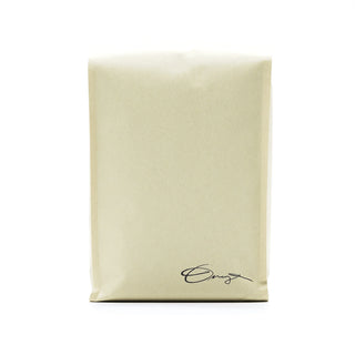 Monarch coffee bag in light kraft with handwritten signature at the bottom