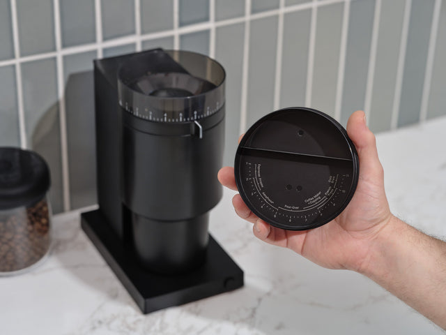 Fellow Opus Conical Burr Grinder, Matte Black, from Clive Coffee, grind settings on lid, lifestyle large