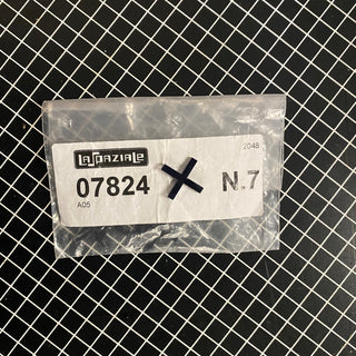 La Spaziale Float Retainer Cross black cross pieces in a clear bag on a grid cutting mat.