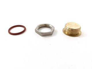 Drip tray drain plug components red rubber O ring silver hex nut and brass cap laid out on white surface