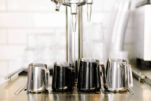 The whole family of Fellow Eddy milk steaming pitchers, polished stainless and graphite, Clive Coffee - Lifestyle